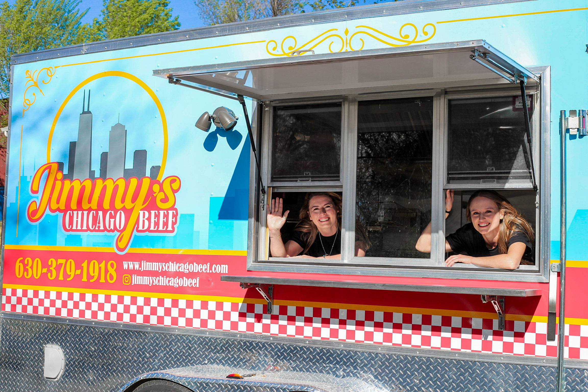 Jimmy's Chicago Beef food truck with the team waving from the service window